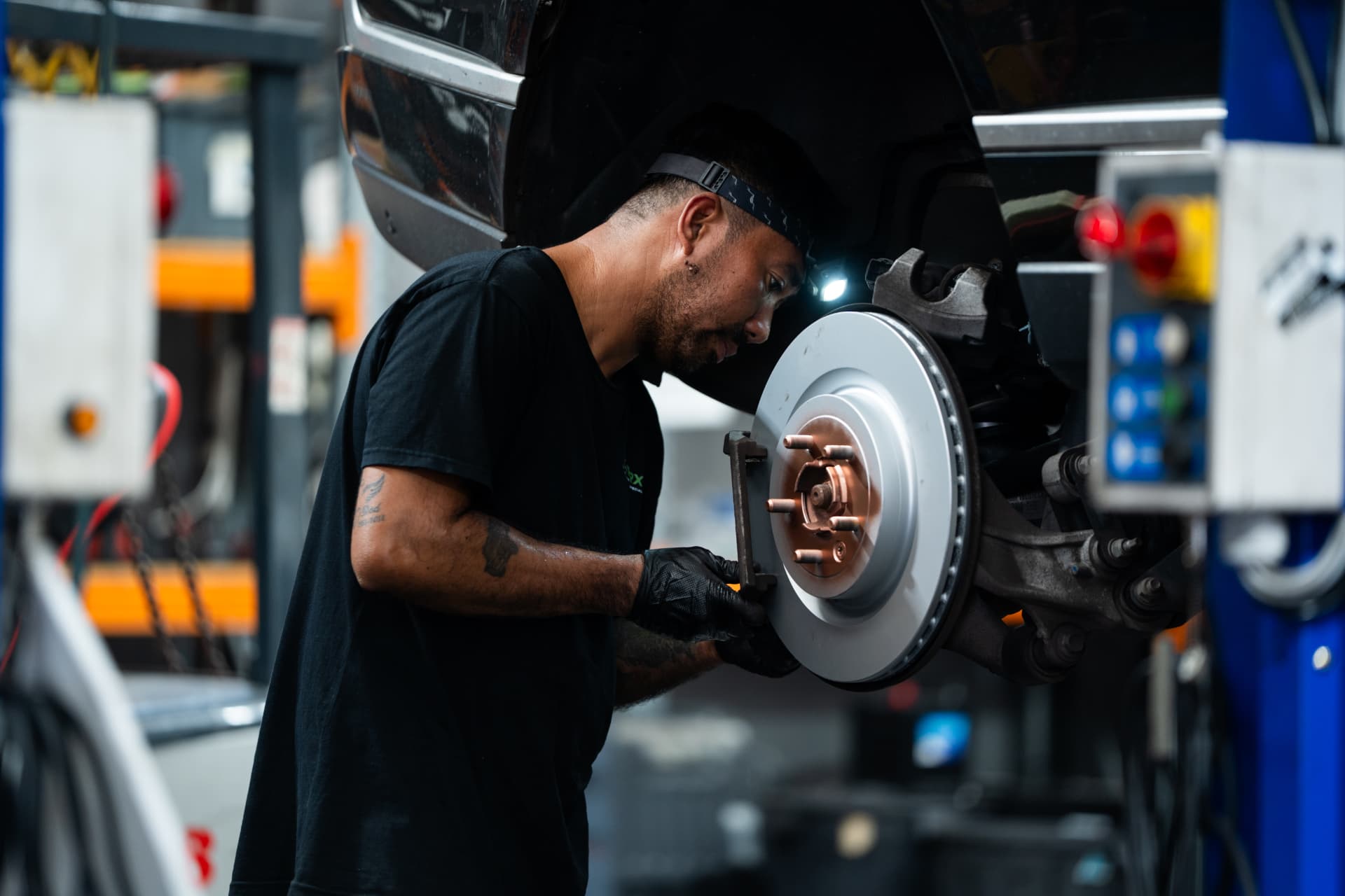 RoverX technician fitting new brake discs to a Range Rover