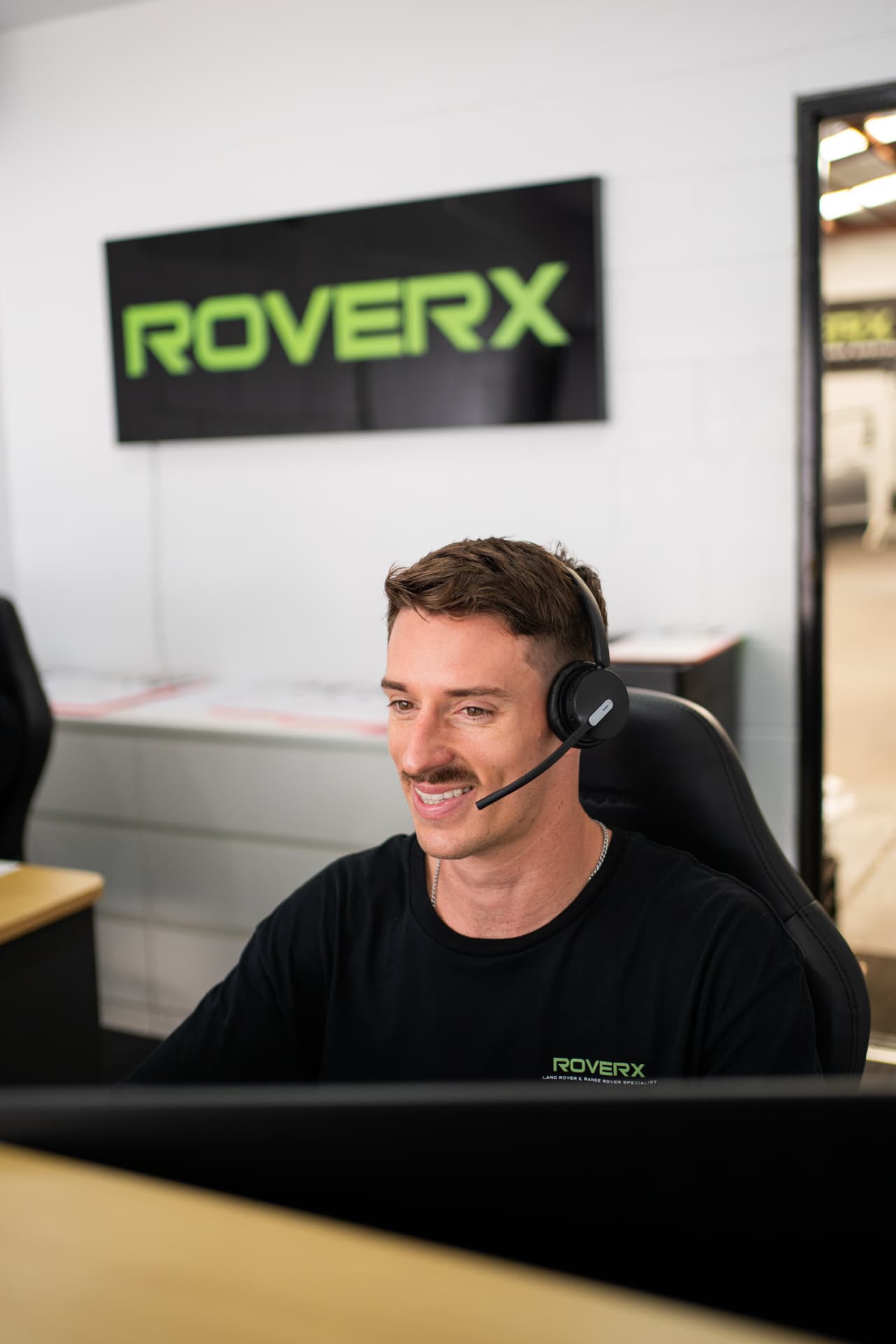 Tom Hardwick taking a call at the RoverX workshop