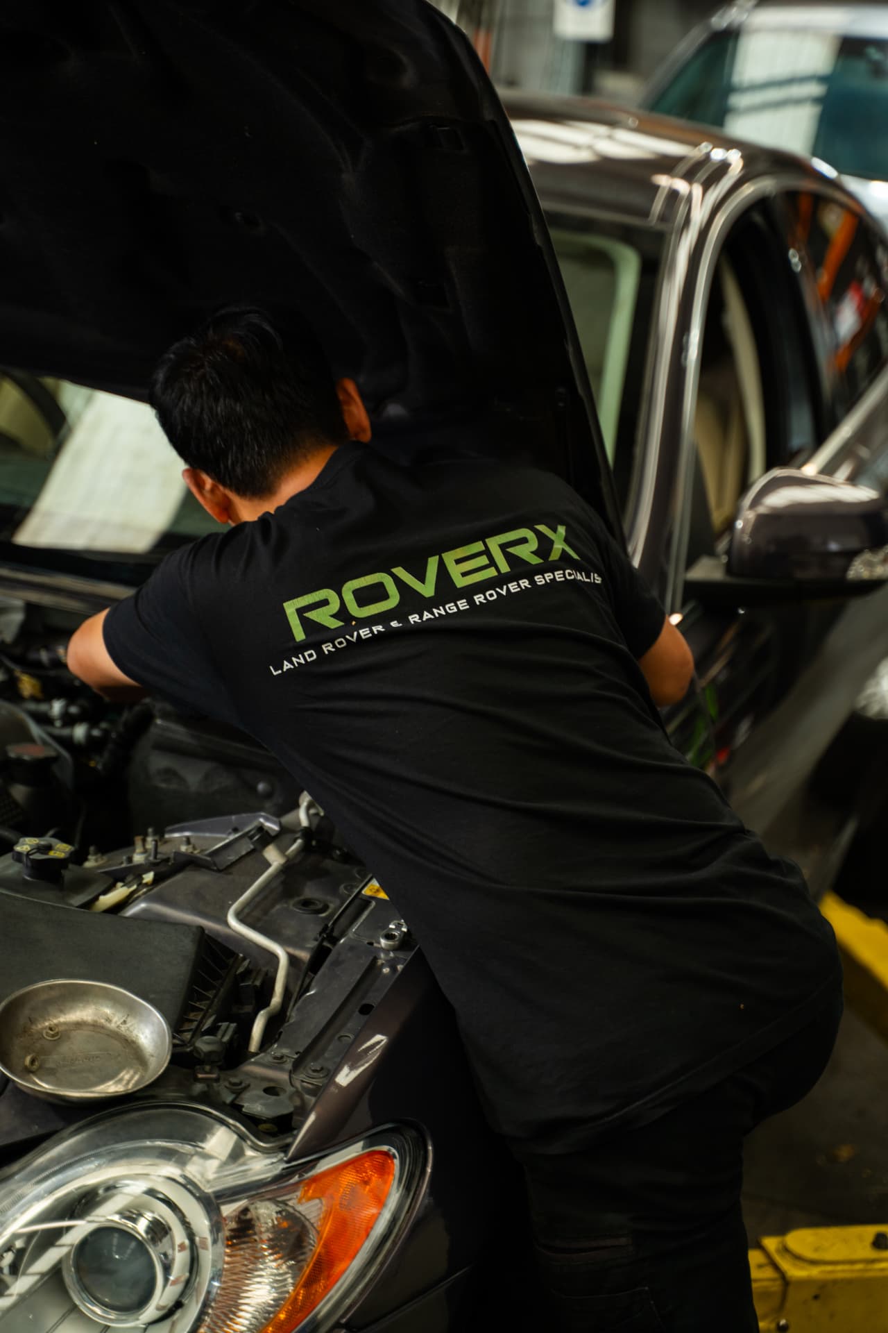 RoverX technician working in a Land Rover engine bay